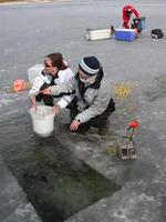 FWR students taking dredge sample from lake bottom