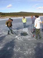 FWR students removing ice block to retrieve prairie jigger board